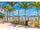 Picturesque outdoor dining area with palm trees, colorful umbrellas, and waterfront views in Englewood, Florida at 929 Suncrest Ln, Englewood, FL 34223