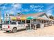 Charming Lock 'N Key Restaurant & Pub with colorful umbrellas and curbside to-go parking in Englewood, Florida at 929 Suncrest Ln, Englewood, FL 34223