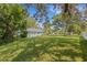 Large backyard with lush grass and mature trees at 2403 Palma Sola Blvd, Bradenton, FL 34209