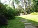 Landscaped backyard with stone pathway at 2403 Palma Sola Blvd, Bradenton, FL 34209