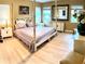 Elegant bedroom with hardwood floors, a large bed, and stylish furniture at 2403 Palma Sola Blvd, Bradenton, FL 34209