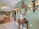 Elegant entryway with tiled floor, antique furniture, and a view into the living area at 2403 Palma Sola Blvd, Bradenton, FL 34209