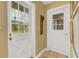 Inviting entry with a charming white door and stained-glass sidelights at 2403 Palma Sola Blvd, Bradenton, FL 34209