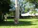 Landscaped front yard with lush green grass and mature trees at 2403 Palma Sola Blvd, Bradenton, FL 34209