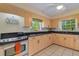 Kitchen with light wood cabinets, granite countertops, and stainless steel appliances at 2403 Palma Sola Blvd, Bradenton, FL 34209