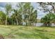 Landscaped backyard with lush grass and serene waterfront views at 284 Corelli Dr, Nokomis, FL 34275