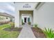 Brick walkway leading to a house with a purple door and white walls at 284 Corelli Dr, Nokomis, FL 34275