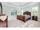 Spacious main bedroom with a king-size bed and large windows at 284 Corelli Dr, Nokomis, FL 34275