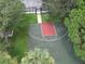 Aerial view of the basketball court among mature trees and landscaping at 4938 72Nd E Ct, Bradenton, FL 34203