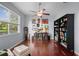 Inviting living room with wood floors, ceiling fan, and shelving at 4938 72Nd E Ct, Bradenton, FL 34203