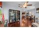 Open floor plan with wood floors connects the living room to the dining area and kitchen at 4938 72Nd E Ct, Bradenton, FL 34203