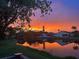 Beautiful sunset reflecting in the serene pond with neighborhood homes silhouetted against the colorful sky at 4938 72Nd E Ct, Bradenton, FL 34203