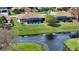 Scenic aerial view of a home featuring a screened-in pool, lush green lawn, and waterfront access at 56 Broadmoor Ln, Rotonda West, FL 33947