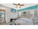 Well-lit bedroom featuring a flat screen tv and natural light from nearby windows at 56 Broadmoor Ln, Rotonda West, FL 33947