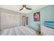 Bedroom with light-colored walls features a closet and mounted television at 56 Broadmoor Ln, Rotonda West, FL 33947