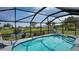 Relaxing screened-in pool area with comfortable lounge chairs and scenic backyard views at 56 Broadmoor Ln, Rotonda West, FL 33947