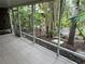 Screened porch with tile flooring and lush backyard views at 642 N Jefferson Ave # 13, Sarasota, FL 34237