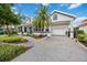 White house with teal door, landscaped yard, and driveway at 302 Americas Cup Blvd, Bradenton, FL 34208