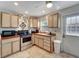 Kitchen with stainless steel appliances and wood cabinets at 4020 School S Ave, Sarasota, FL 34231