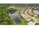 Aerial view of community with lake, houses, and green spaces at 6912 Gosport Cv, Lakewood Ranch, FL 34202