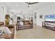 Spacious living room featuring brown leather sofas and a large TV at 6912 Gosport Cv, Lakewood Ranch, FL 34202