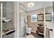 Clean bathroom with a shower, toilet, and modern vanity at 2132 Roselawn St, Sarasota, FL 34231