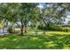 Peaceful backyard with hammock, trees, and lawn at 6414 Glen Abbey Ln, Bradenton, FL 34202