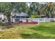 Landscaped backyard, featuring a white fence and red mulch at 6414 Glen Abbey Ln, Bradenton, FL 34202