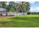 Large backyard with palm trees, white fence, and lush grass at 6414 Glen Abbey Ln, Bradenton, FL 34202