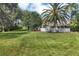 Spacious backyard with lush lawn and mature trees at 6414 Glen Abbey Ln, Bradenton, FL 34202