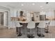 Modern kitchen with large island and seating, white cabinets and stainless appliances at 6414 Glen Abbey Ln, Bradenton, FL 34202