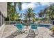 Spacious pool area with lounge chairs and palm trees at 6414 Glen Abbey Ln, Bradenton, FL 34202