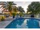 Evening view of the pool and spa area with lighting at 6414 Glen Abbey Ln, Bradenton, FL 34202