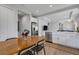 Open concept kitchen with white cabinets, farmhouse sink, and stainless steel appliances at 10109 Spruce River Way, Parrish, FL 34219