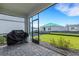 Screened patio with paver stones and grill, overlooking backyard at 10109 Spruce River Way, Parrish, FL 34219