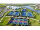 Aerial view showing tennis courts, pickleball courts, a basketball court, and a clubhouse at 15909 Tradewind Ter, Lakewood Ranch, FL 34211