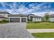 Two-story house with a two-car garage and landscaped lawn at 15909 Tradewind Ter, Lakewood Ranch, FL 34211