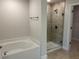 Modern bathroom featuring a glass-enclosed shower and a separate soaking tub at 1010 Huntington St, North Port, FL 34288