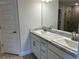 Bathroom featuring double vanity with marble top, modern fixtures, and large mirror at 1010 Huntington St, North Port, FL 34288