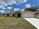 Charming single-story home with a manicured lawn and attached two car garage at 1010 Huntington St, North Port, FL 34288