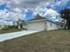 Charming home featuring a two-car garage, well-maintained lawn, and stucco siding at 1010 Huntington St, North Port, FL 34288
