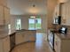 Modern kitchen with white cabinets, stone countertops, and stainless steel appliances at 1010 Huntington St, North Port, FL 34288