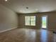 Spacious living room with tile floors, recessed lights, and access to the backyard at 1010 Huntington St, North Port, FL 34288