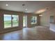 Bright living room with tile floors, recessed lighting, and rear yard access at 1010 Huntington St, North Port, FL 34288