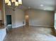Open-concept living area with tile flooring and views of the kitchen and other rooms at 1010 Huntington St, North Port, FL 34288
