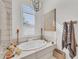 Relaxing bathroom with a free-standing tub and large window at 17745 Lucaya Dr, Lakewood Ranch, FL 34202
