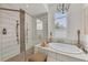 Elegant bathroom with soaking tub, walk-in shower, and modern fixtures at 17745 Lucaya Dr, Lakewood Ranch, FL 34202