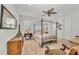 Charming bedroom with a four-poster bed, ceiling fan, and ample natural light at 17745 Lucaya Dr, Lakewood Ranch, FL 34202