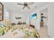 Relaxing bedroom with a tropical theme, comfortable bed, and access to a patio at 17745 Lucaya Dr, Lakewood Ranch, FL 34202