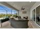 Relaxing covered patio with wicker furniture, overlooking a pool and lake at 17745 Lucaya Dr, Lakewood Ranch, FL 34202
